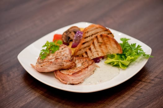 Pork chop with vegetable at plate