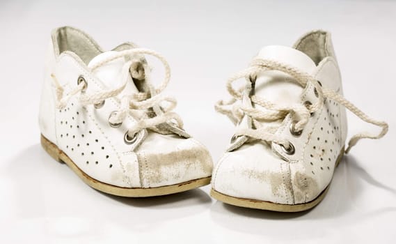 Kids Shoes Untied on white background.