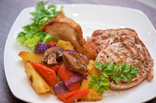 Pork chop with vegetable at plate