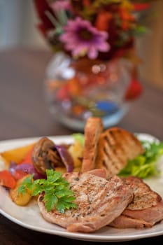 Pork chop with vegetable at plate