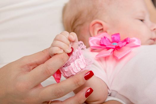 a two-month baby lying on his back on his knees, and the mother's womb