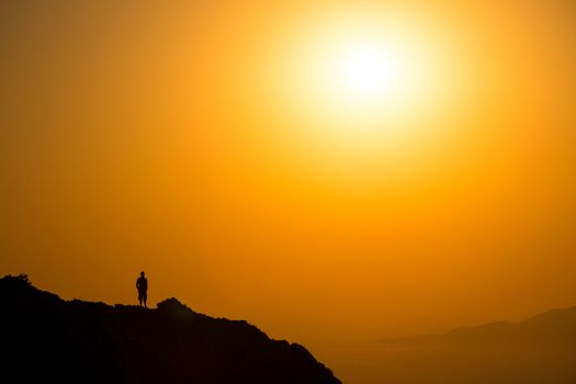 Landscape view of beautiful colorful sunrise above the ocean with horizon and distant islands, Santorini, Greece