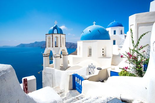 Scenic view of traditional cycladic white houses and blue domes in Oia village, Santorini island, Greece