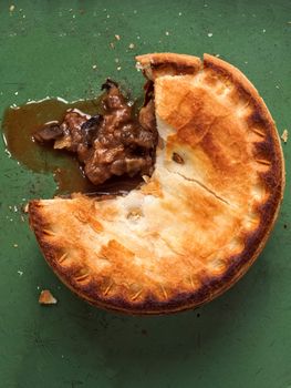 close up of rustic meat and mushroom pie