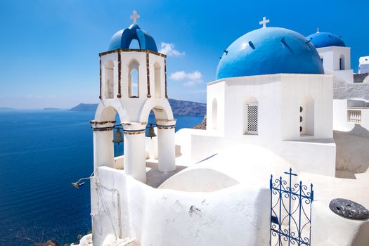 Scenic view of traditional cycladic blue white and blue domes in Oia village, Santorini island, Greece