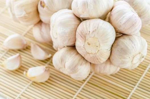 Organic garlic whole on the wooden mat background