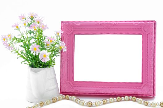 Flowers vase and pink blank vintage picture frame on white background, save clipping path.