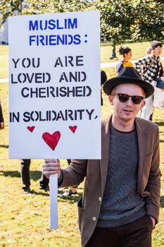 UNITED STATES, Austin: A protester holds a sign expressing support for Muslims at a protest against governor Greg Abbott's attempts to stop Syrian refugees from resettling in the state in Austin on November 22, 2015. Last week Abbott joined more than half the nation's 50 governors in vowing to refuse Syrian refugees entry following the terror attacks in Paris. 