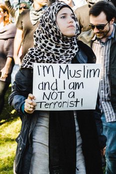 UNITED STATES, Austin: A protester holds a sign reading I'm Muslim and I am not a terrorist at a protest against governor Greg Abbott's attempts to stop Syrian refugees from resettling in the state in Austin on November 22, 2015. Last week Abbott joined more than half the nation's 50 governors in vowing to refuse Syrian refugees entry following the terror attacks in Paris. 