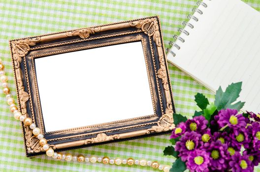 Vintage photo frame with flower on beautiful fabric background. Save clipping path.