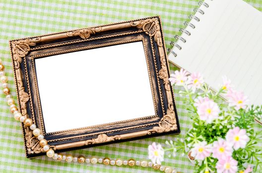 Old vintage photo frame with open diary on beautiful fabric background. Save clipping path.