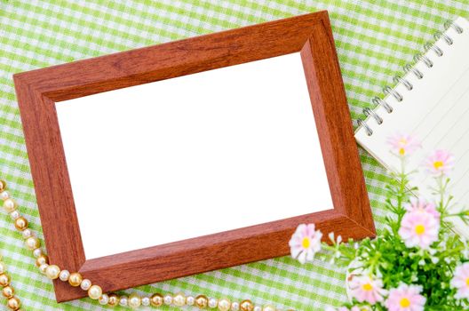 Wooden photo frame with flower on beautiful background. Save clipping path.