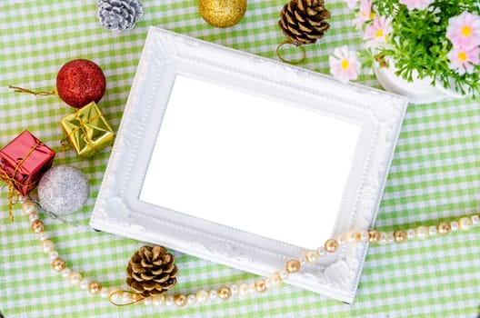 Vintage white photo frame with christmas decoration with flower on beautiful fabric background. Save clipping path.