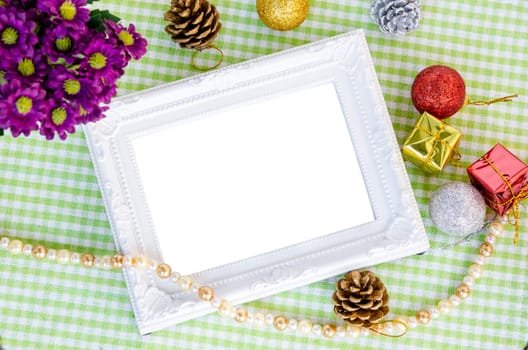 Vintage white photo frame with christmas decoration with flower on beautiful fabric background. Save clipping path.