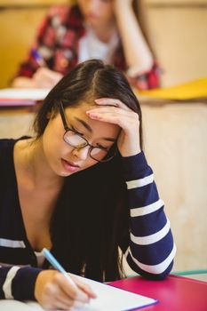 Thoughtful student studying on notebook at the university