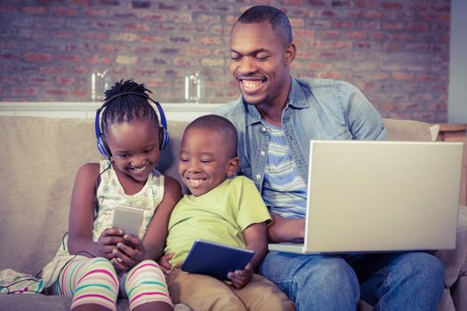 Happy family using technology together in living room