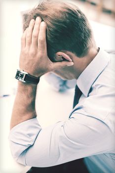 business, office, school and education concept - stressed businessman with papers at work