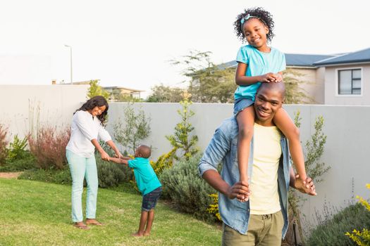 Family having fun in the garden of the house 