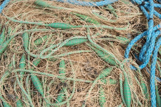 Crowded of fishing net with green and blue ropes