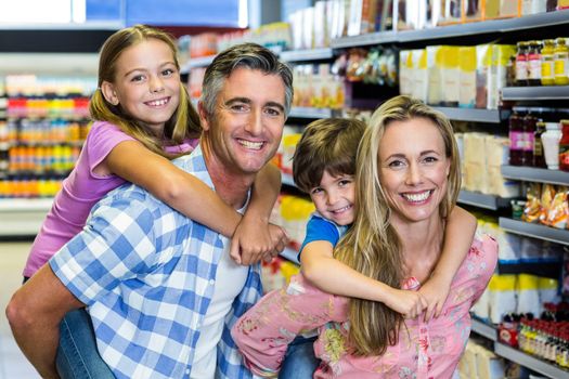 Portrait of happy family at the supermarket