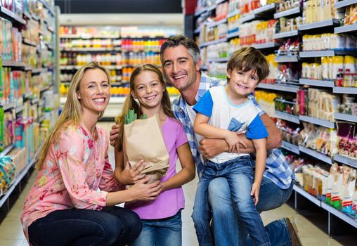 Portrait of happy family at the supermarket