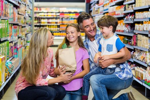 Portrait of happy family at the supermarket