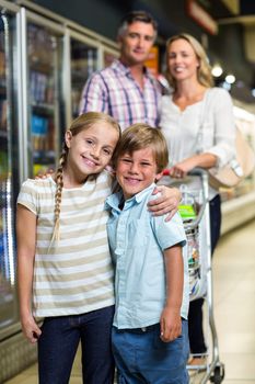 Portrait of happy family at the supermarket