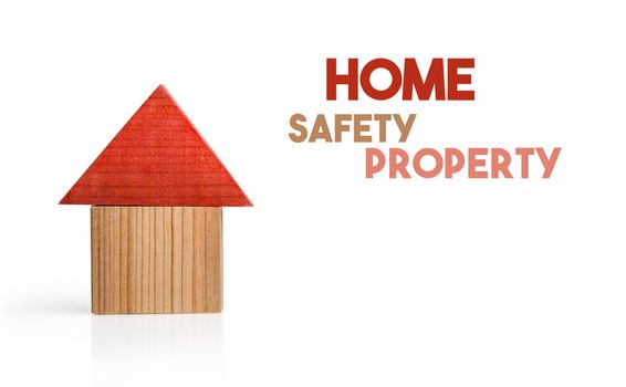 Wooden house model as a symbol of safety living.