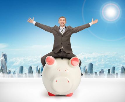 Businessman sitting on piggy bank on nature background