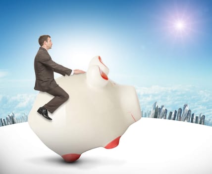 Businessman sitting on piggy bank on nature background