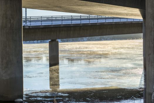 Mist on Icy River under Bridge in Umea, Sweden