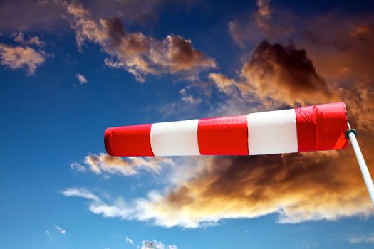 horizontally flying windsock against stormy clouds