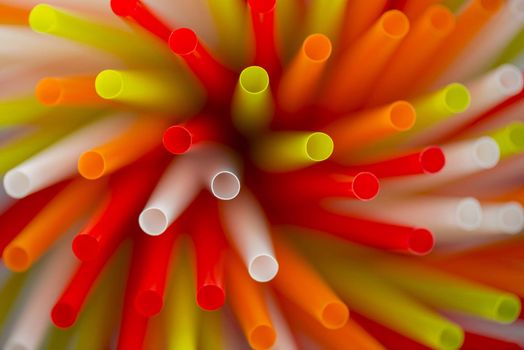 Collection colored drinking straws in blur
