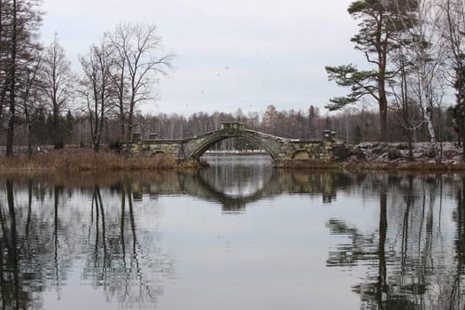 Humpback Bridge in Gatchina park, uniting the two islands in the White Lake. Leningrad, November 2015