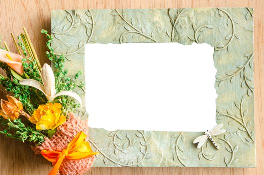 Blank photo frame and pink rose on wooden background. save clipping path.