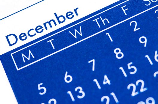 Close up of spiral bound calendar displaying month of December.