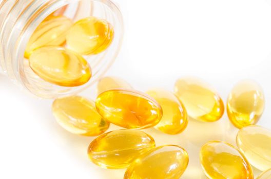 Closeup the yellow soft gelatin supplement omega 3 , fish oil capsule