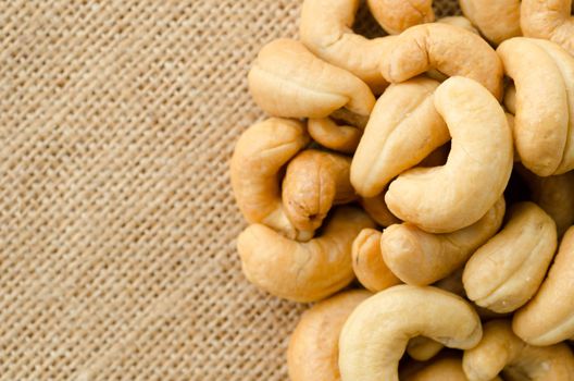 Close up Roasted cashews on sack background