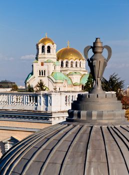 A view of golden domes st. Aleksander Nevski cathedral in Sofia, Bulgaria through a detail on a roof of a building. Vertical image.