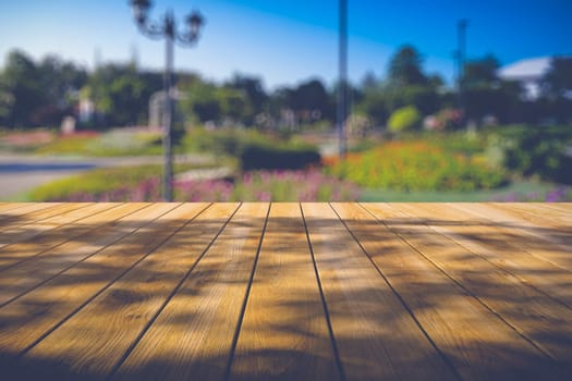 Beautiful sunlight in the autumn forest with wood planks floor, nature background, bokeh background