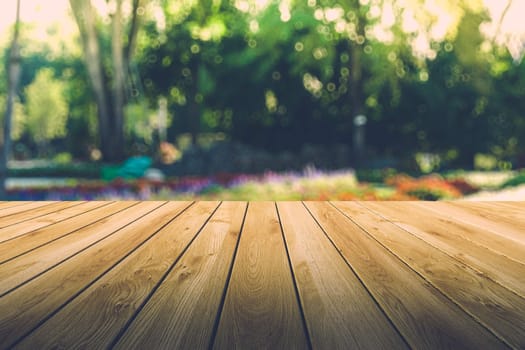 Beautiful sunlight in the autumn forest with wood planks floor, nature background, bokeh background