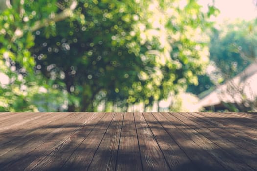 Beautiful sunlight in the autumn forest with wood planks floor, nature background, bokeh background