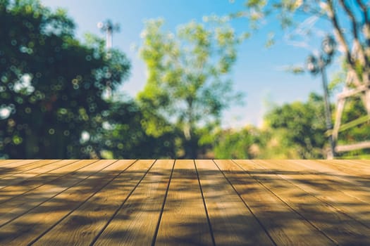 Beautiful sunlight in the autumn forest with wood planks floor, nature background, bokeh background