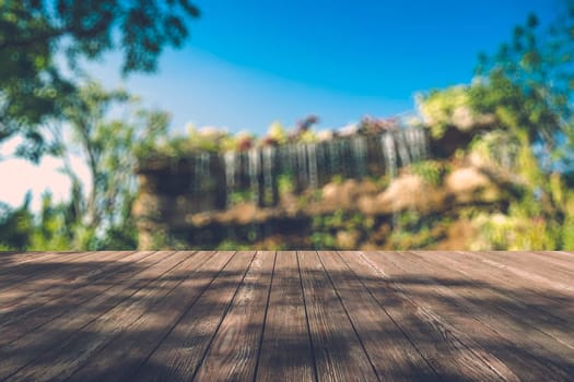 Beautiful sunlight in the autumn forest with wood planks floor, nature background, bokeh background