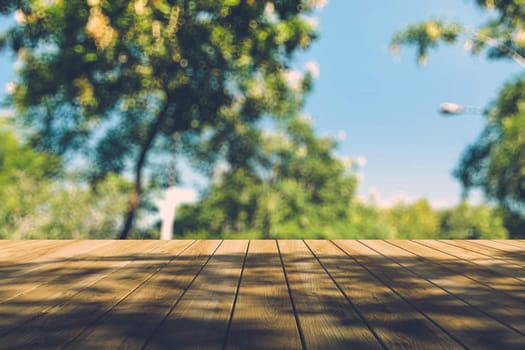 Beautiful sunlight in the autumn forest with wood planks floor, nature background, bokeh background