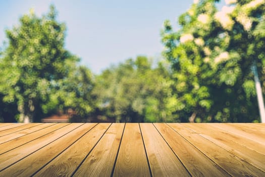 Beautiful sunlight in the autumn forest with wood planks floor, nature background, bokeh background