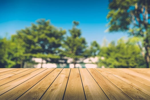 Beautiful sunlight in the autumn forest with wood planks floor, nature background, bokeh background