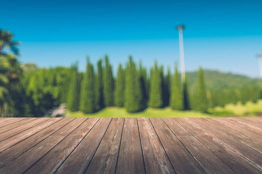 Beautiful sunlight in the autumn forest with wood planks floor, nature background, bokeh background