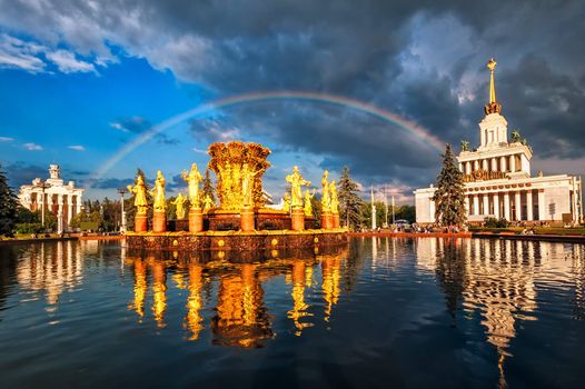 Rainbow over golden fountain and neo classical pavillon at the National Exhibition Center, Moscow, Russia