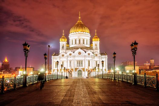 Golden domes of Christ the Saviour Cathedral glowing in night lights, Moscow, Russia